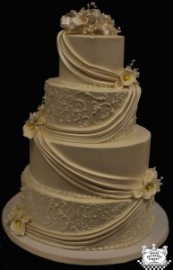 4 Tier Ivory Round Wedding Cake with Flowers and Swags with 6" Tiers by Three Brothers Bakery