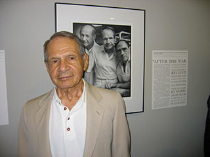Sigmund in front of Mark Seliger's photo used in his book When They Came To Take My Father - a compilation of photos and narratives of Holocaust survivors.